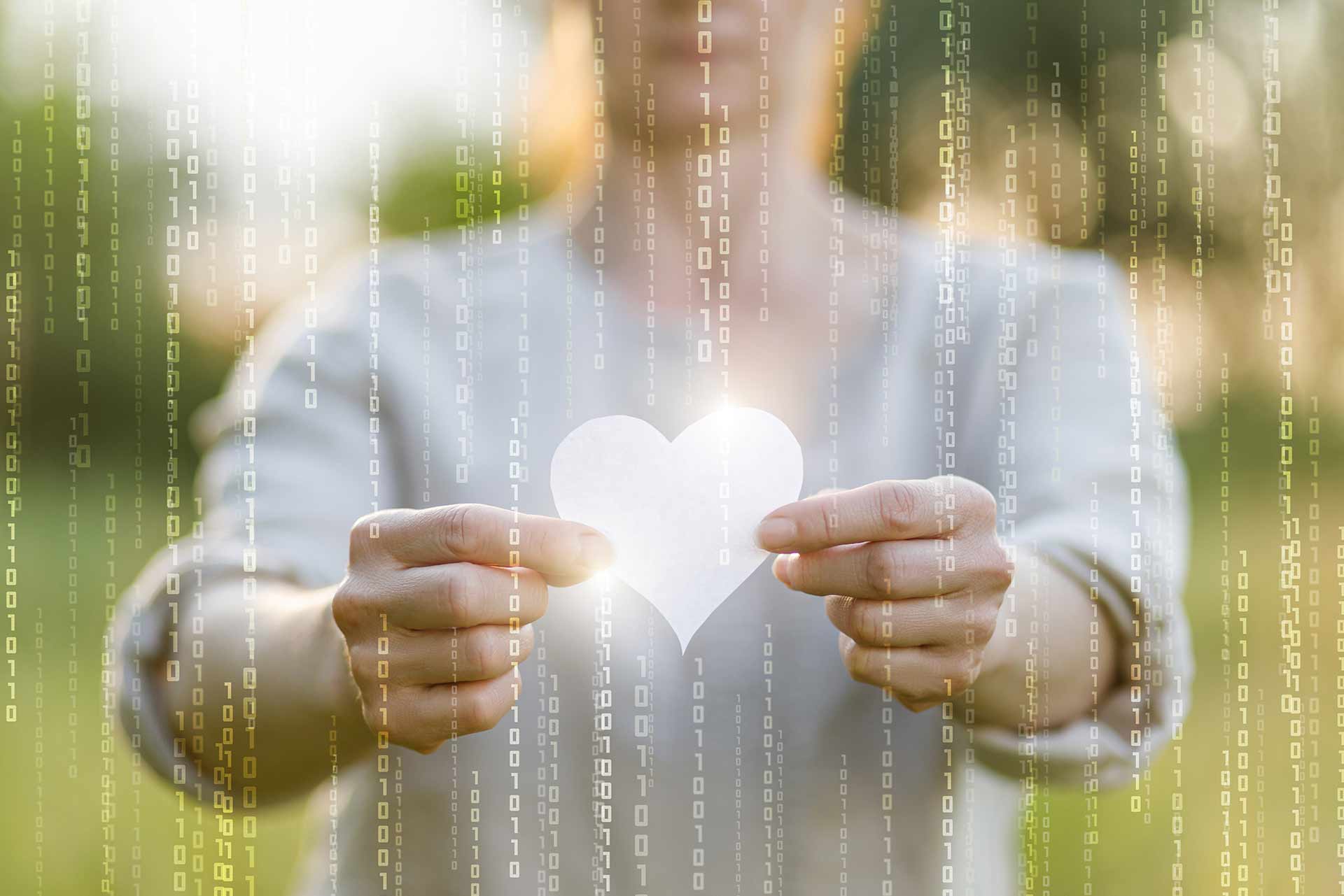 Woman holding heart with binary code