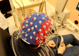 Person wearing an EEG cap during an experiment